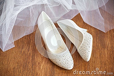 Pair of women formal high heel shoes stands on wooden floor parquet. morning gathering dressing bride accessories Stock Photo