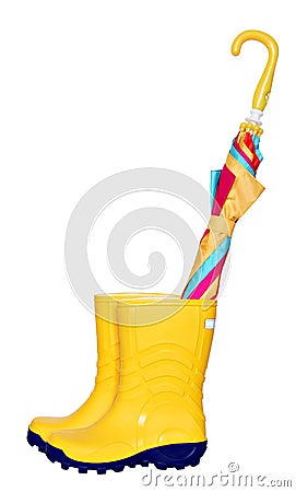 Pair of yellow rubber boots with colorful umbrella Stock Photo