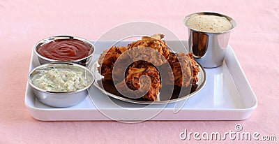 Pakoda Traditiional and Popular Indian Vegetarian Snack and Coconut Chutney and Tomato Ketchup Stock Photo