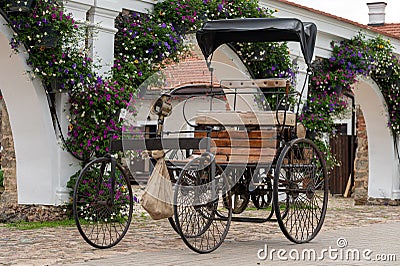 Pakruojis Manor Park. An ancient four-wheeled motor carriage to the wall Editorial Stock Photo