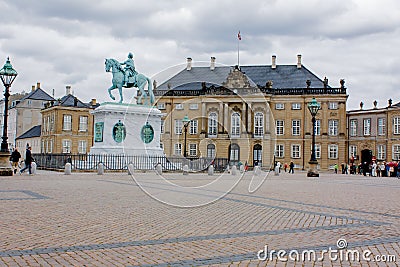 Palace with a monumental equestrian statue of Amalienborg`s founder, King Frederik V, Copenhagen, Denmark Editorial Stock Photo
