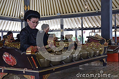 Palace servants performing traditional musical instruments called Gamelan under a large gazebo Editorial Stock Photo