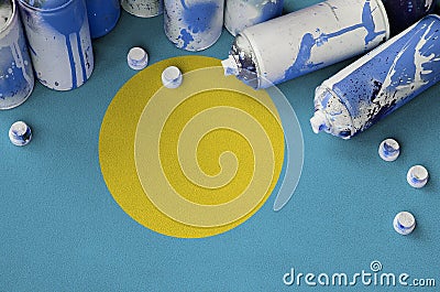 Palau flag and few used aerosol spray cans for graffiti painting. Street art culture concept Stock Photo