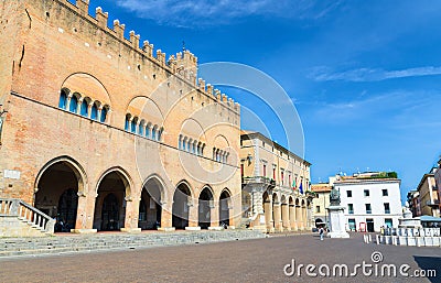 Palazzo dell`Arengo palace building with arches and Pope Paul V statue on Piazza Cavour square in Rimini Editorial Stock Photo