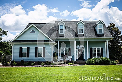 Front View of blue house with siding in the suburbs Stock Photo