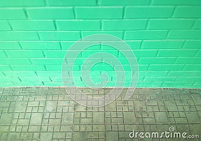 Pale green symmetric street brick wall background Stock Photo