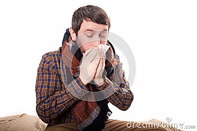 Pale sick man with a flu, sneezing, in a clean background Stock Photo