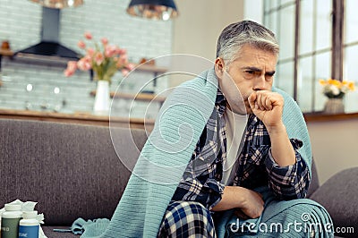 Pale sick mature man staying at home Stock Photo