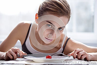 Pale underweight woman cutting a tomato Stock Photo