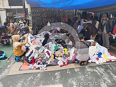 Portrait of people buying clothes at the street market with Miscellaneous backgrounds Editorial Stock Photo