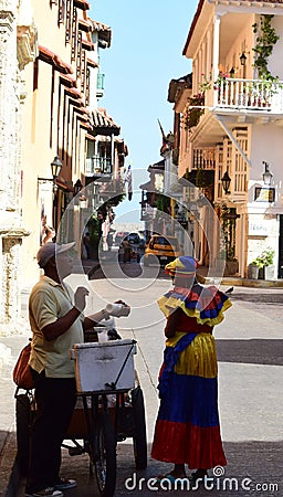 Palenquera woman and a peddler in Cartagena Editorial Stock Photo