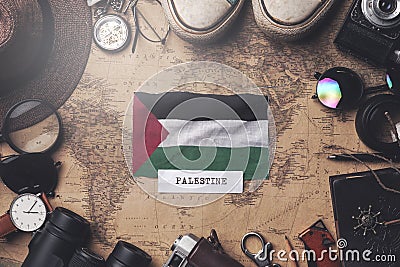 Palestine Flag Between Traveler`s Accessories on Old Vintage Map. Overhead Shot Stock Photo
