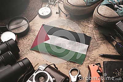 Palestine Flag Between Traveler`s Accessories on Old Vintage Map. Tourist Destination Concept Stock Photo