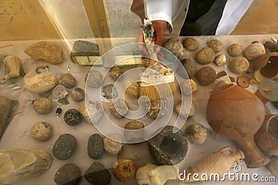 Palestinian cleans artifacts at the museum, while the Ministry of Tourism announced the closure of tourist places due to the outbr Editorial Stock Photo