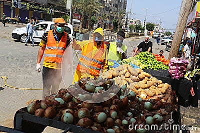 Palestinian municipality workers sterilize public parks and roads with the deployment of police during the fifth day to impose a c Editorial Stock Photo