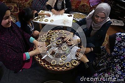 Palestinian women prepare traditional cookies ahead of the Eid al-Fitr festivities Editorial Stock Photo