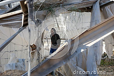 Palestinians inspect the damage at the site of an Israeli air strike Editorial Stock Photo