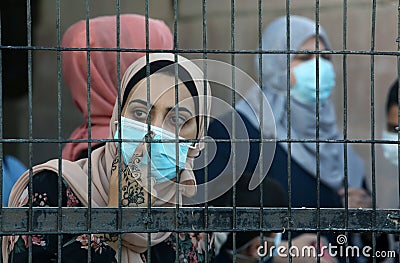 Palestinians wait to cross over to the Egyptian side of the Rafah border crossing Editorial Stock Photo