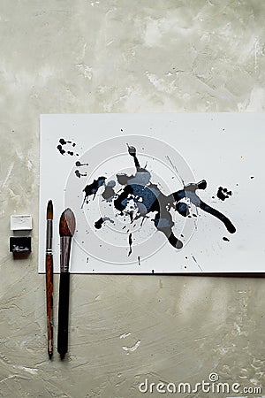 Palette of black and white paint. a sheet of white art paper with black dye ink. Stock Photo