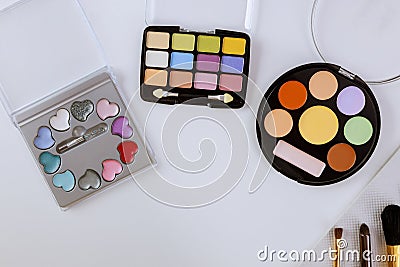 Palette of multicolor cosmetic makeup with a eyeshadow palette, colorful shadows minimalism on isolated white background Stock Photo