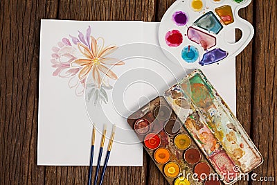 Palette, paint brushes and white sheet Stock Photo