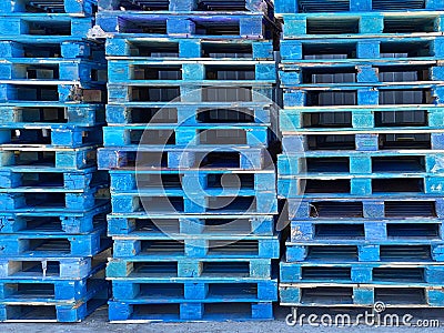 pallet shipping receiving wood stacked palates trucking logistics wooden generic strong support rack warehouse painted blue cargo Stock Photo