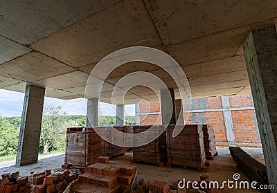 Pallets with red bricks at the stage of construction in a new building Stock Photo