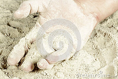 The palm of a hand covered with sand Stock Photo