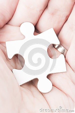 Palm of human hand hold white piece of a puzzle Stock Photo