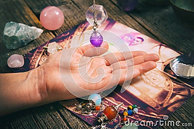 Palm reading with pendulum Stock Photo