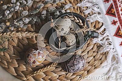 Palm Sunday in the Ukrainian style. Easter eggs, quail eggs, black vintage cup. Top view. Stock Photo