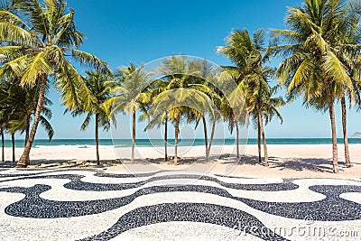Palm trees and the iconic Copacabana beach mosaic sidewalk Stock Photo