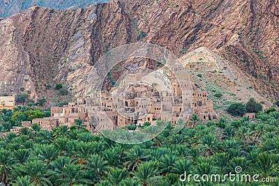 Palm trees and a traditional mountain village in Nizwa,Oman Stock Photo