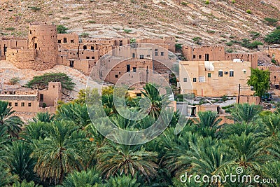 Palm trees and a traditional mountain village in Nizwa,Oman Stock Photo
