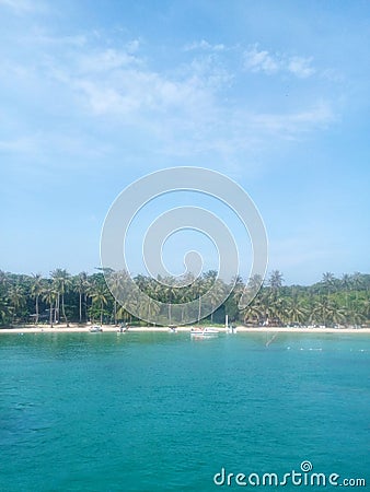 Palm trees, white sand, warm blue sea Stock Photo