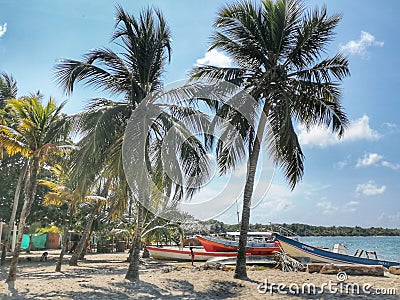 Palmeras y barcos en la playa de rincon del mar en el Caribe colombiano. San onofre, Sucre. Colombia Editorial Stock Photo