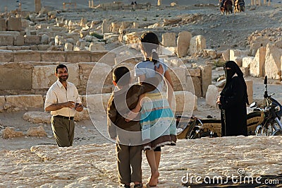 A Syrian family pose for photographs and enjoy the ancient ruins of Palmyra, Syria. Editorial Stock Photo