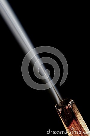 Palo Santo incense stick and smoke on black background. Copy space for text. Burning natural incense stick with smoke. Stock Photo