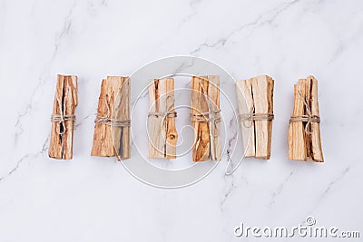 Palo Santo tree sticks on marble background - holy incense tree from Latin America. Meditation, mental health and Stock Photo