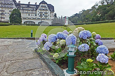 The PalÃ¡cio Quitandinha Palace former luxury resort hotel with beautiful hortensia flowers in PetrÃ³polis Stock Photo