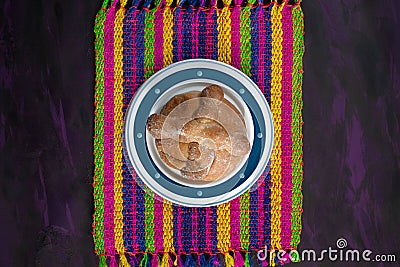 Pan de Muerto, Bread of Dead Mexican Sugar Scone on Woven Tablecloth. Stock Photo