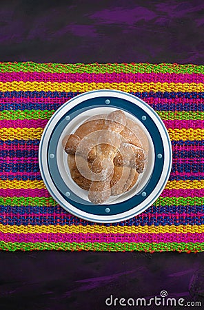 Pan de Muerto, Bread of Dead Mexican Sugar Scone on Woven Tablecloth. Stock Photo