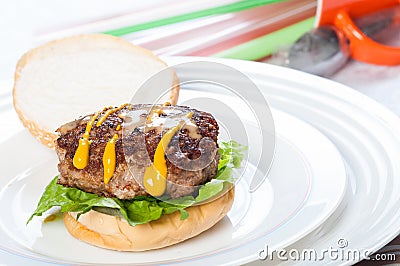 Pan fried burger with mustard and sesame dressings Stock Photo