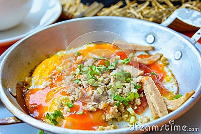 Pan fried egg with topping,Indochina Omelette breakfast. Stock Photo