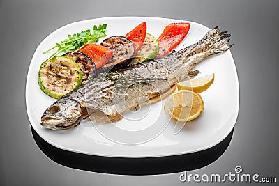 Pan fried grilled roasted cooked whole fish trout sea bass salmon cod Stock Photo