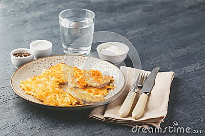 Pan-fried potato pancakes - rosti, kartoffelpuffer, latkes, draniki, hash browns Stock Photo