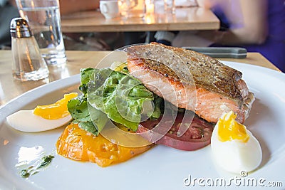 Pan Seared Salmon Filet with Vegetables and Eggs Stock Photo