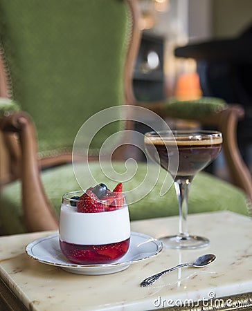 Pana kota dessert and Belgian chocolate on a marble table on a vintage chair Stock Photo