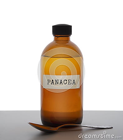 Panacea, magic potion. Old brown glass medicine bottle with spoon, label. Pharmaceutical concept or ironic metaphor Stock Photo