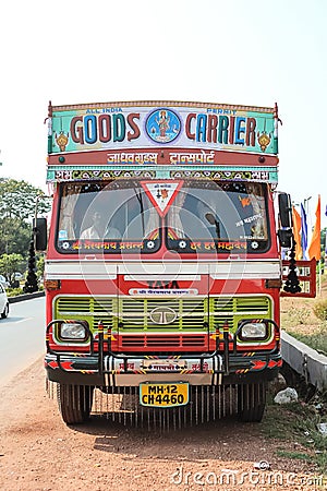 Colorful cargo truck under a summer blue sky with rich decorative paintings, typical for the trucks in India. Editorial Stock Photo